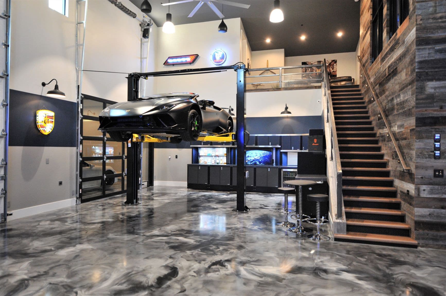 Metallic epoxy floor with swirl pattern under a car